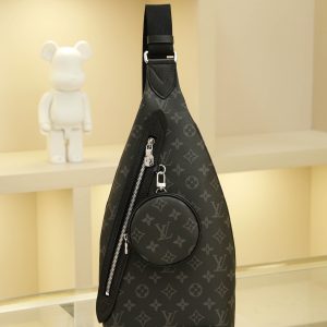 This shoulder bag combines Monogram canvas with Taïga calf leather, featuring a removable zippered pouch for coins or essentials and a zippered side pocket. It reinterprets versatile street style with a relaxed aesthetic, offering an alternative to traditional backpacks. Dimensions: 20 x 42 x 6 cm.